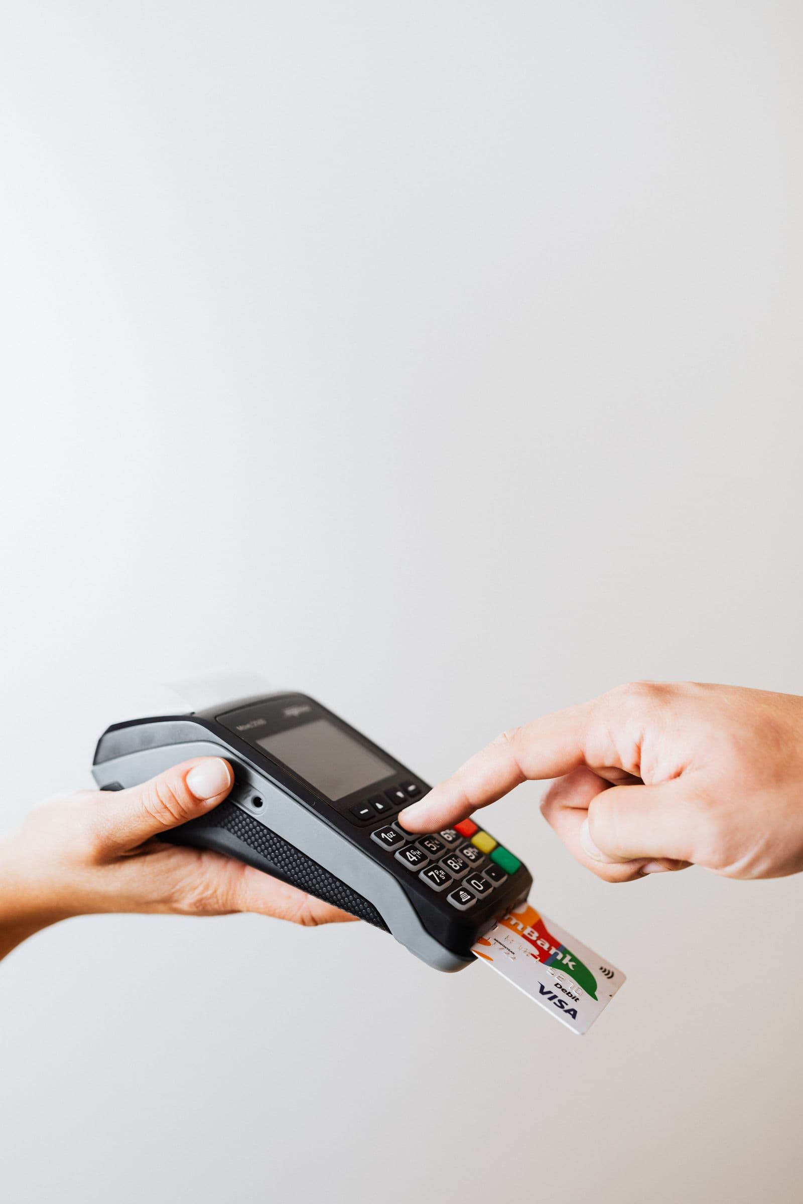 A rewards credit card held between two fingers